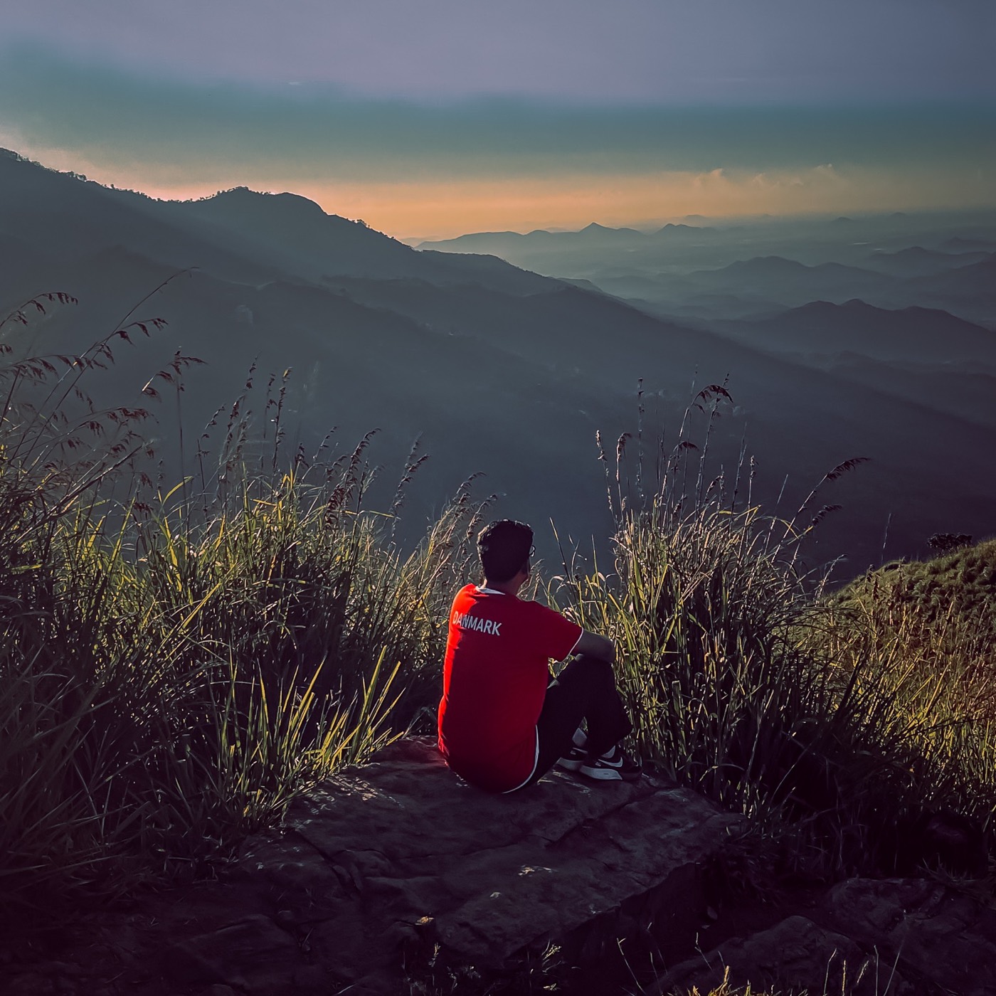 Sitting on a mountain viewpoint at sunrise
