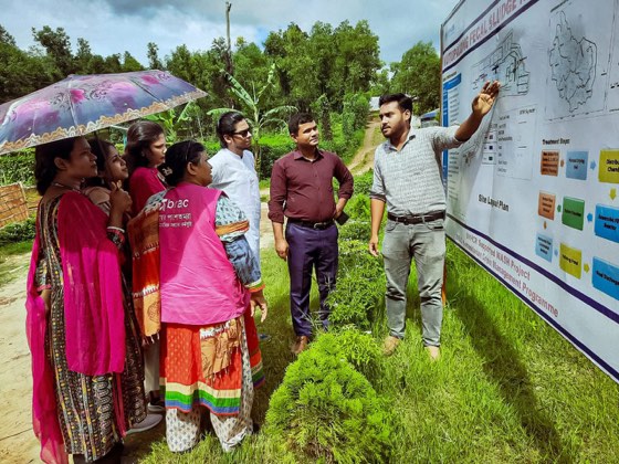 Explaining a field site plan with BRAC colleagues